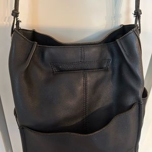 Black gently used Hammit cross body bag. Plenty of compartments for storage!